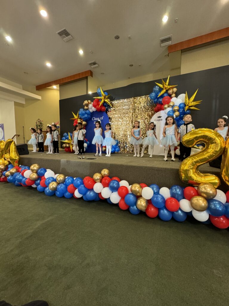 A celebratory stage featuring balloons and a banner that reads 20, marking a significant event or anniversary.